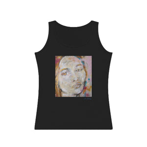 A woman wearing a gray tank top with an abstract portrait design in the center.