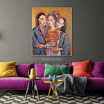 Load image into Gallery viewer, Colorful painting of three women hugging on a gray wall above a purple sofa with colorful cushions.
