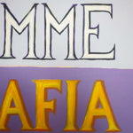 Load image into Gallery viewer, Text 'MME' in white and 'AFIA' in yellow on a purple background
