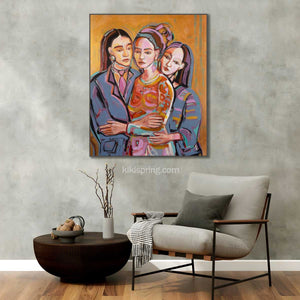 Colorful abstract painting of three women on a gray wall above a modern chair and table.