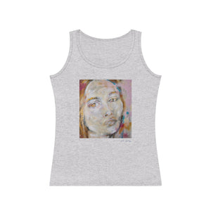 A woman wearing a gray tank top with an abstract portrait design in the center.