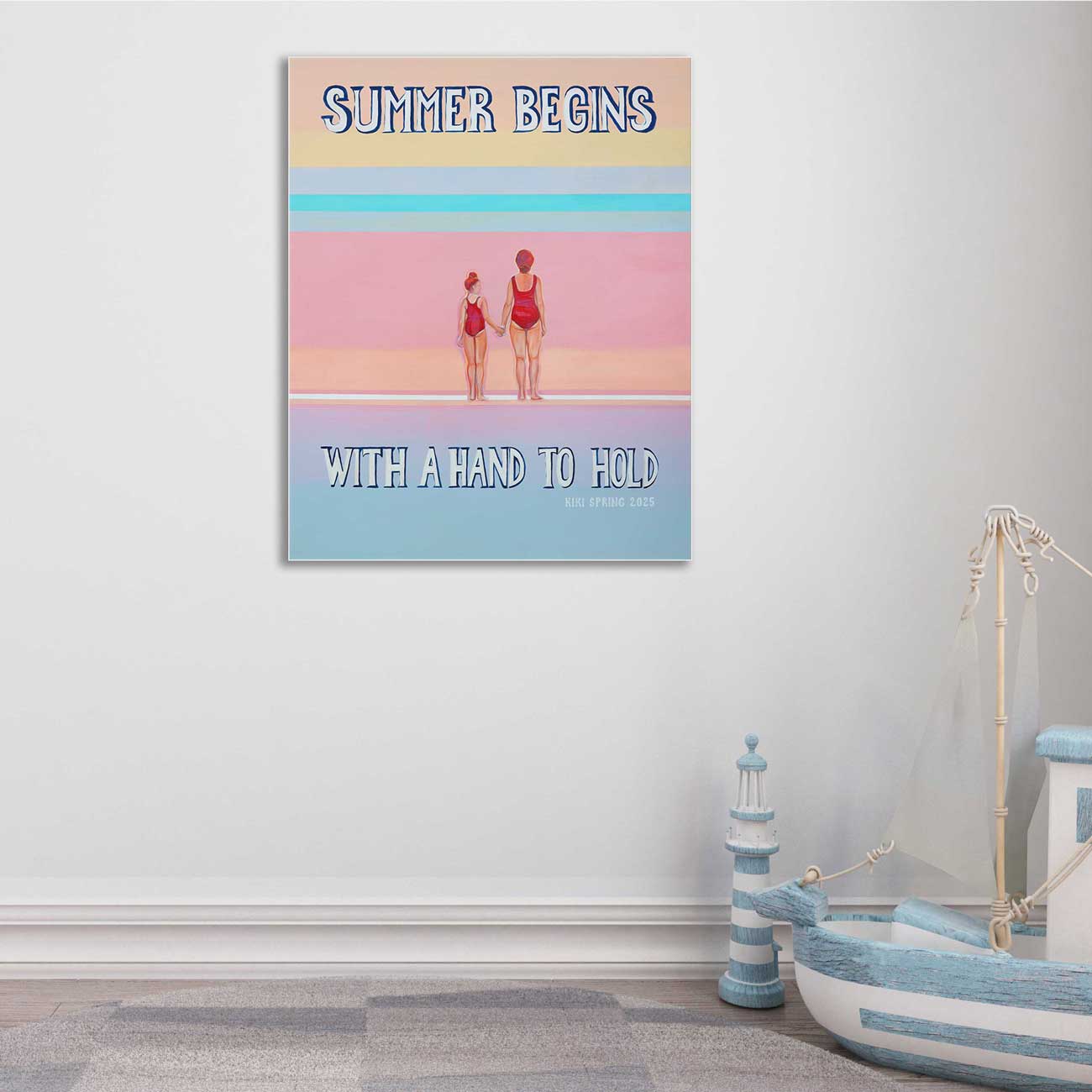 Colorful poster with 'Summer Begins with a Hand to Hold' text and two people in swimsuits, displayed on a wall.