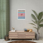 Load image into Gallery viewer, Poster on a wall above a wooden cabinet with decorative items in a room.
