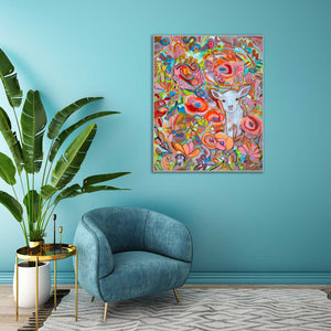 Colorful abstract painting of a lamb with flowers on a blue wall above a blue armchair.
