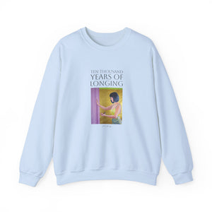 a light-colored sweatshirt with text and a graphic design in the center.