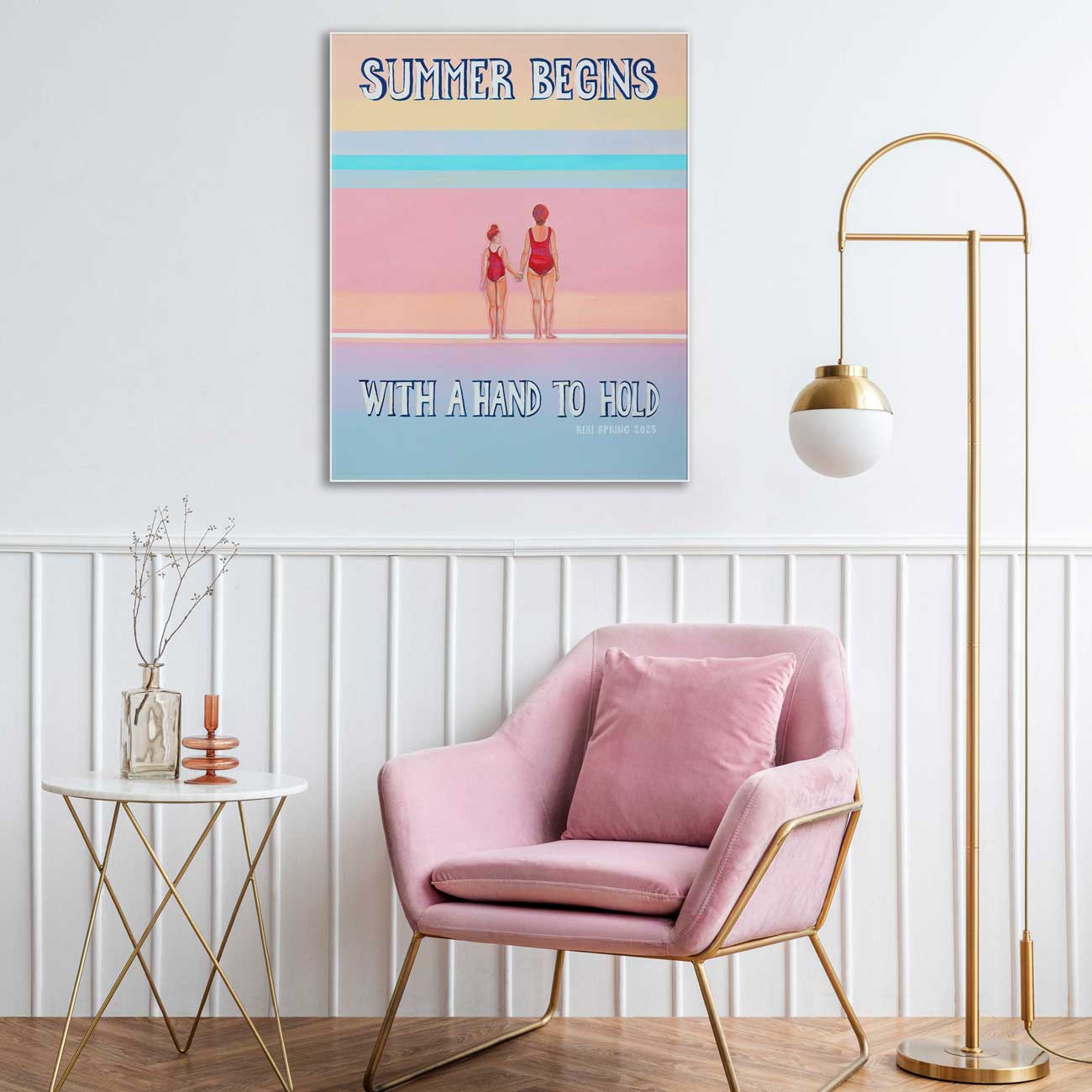 Pink armchair in a room with a 'Summer Begins' poster on the wall.