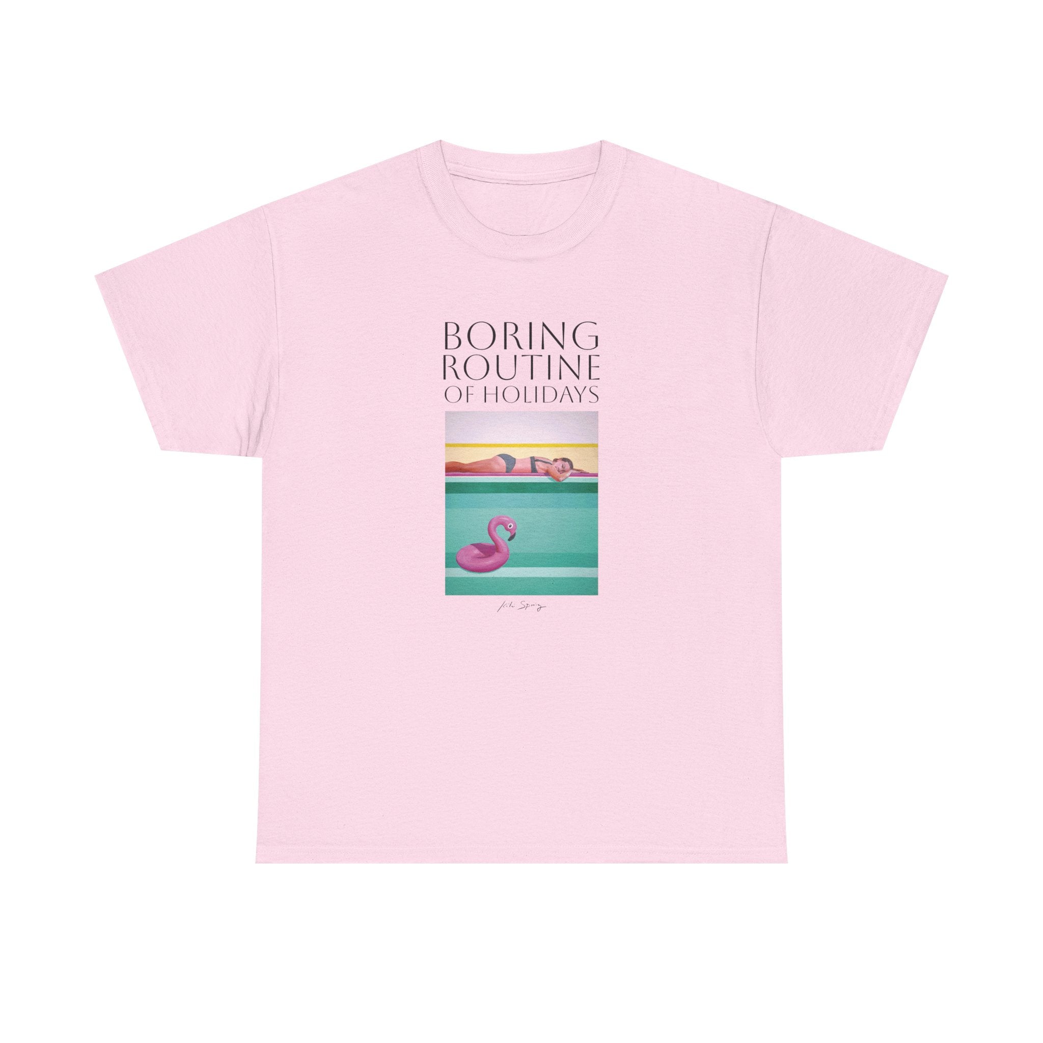 A person wearing a pink unisex crew neck t-shirt with a graphic design and text, standing against a plain background.