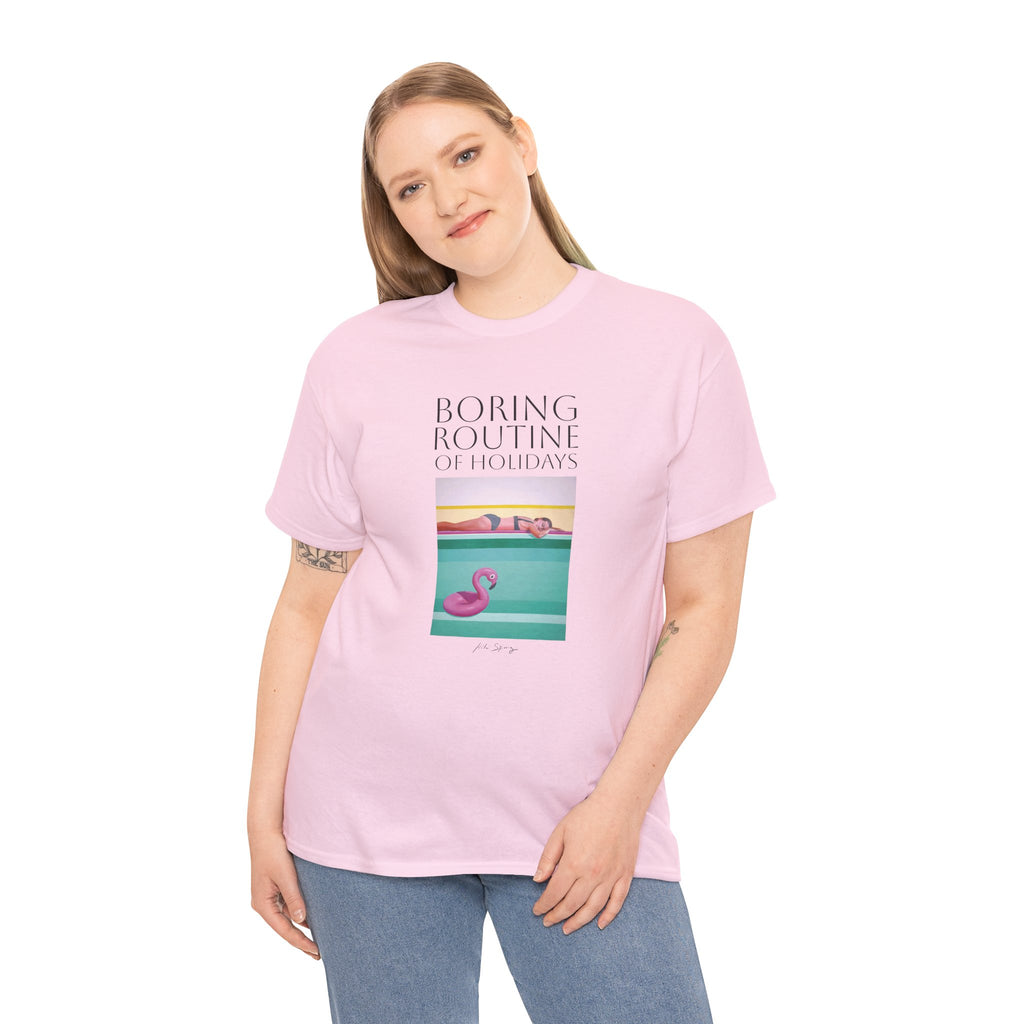 A person wearing a pink unisex crew neck t-shirt with a graphic design and text, standing against a plain background.