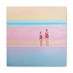 A canvas wall art print featuring a mother and daughter, standing on a beach with pastel-colored water and sky in the background.