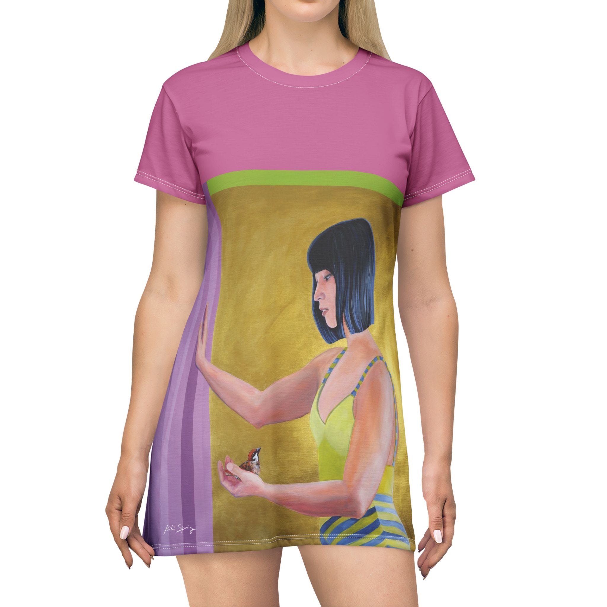 Front view of pink pop‑art T‑shirt dress by Kiki Spring showcasing a clean cut and relaxed fit. The painting portrait of the Asian woman holding a small bird. 