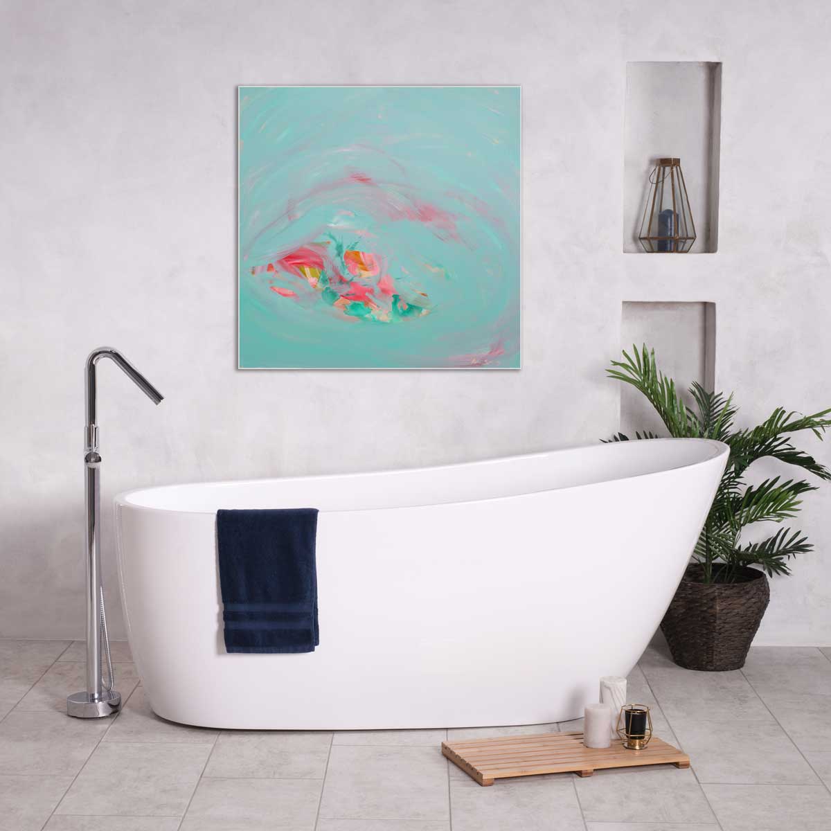 Modern bathroom with a freestanding bathtub, abstract art, and plants.