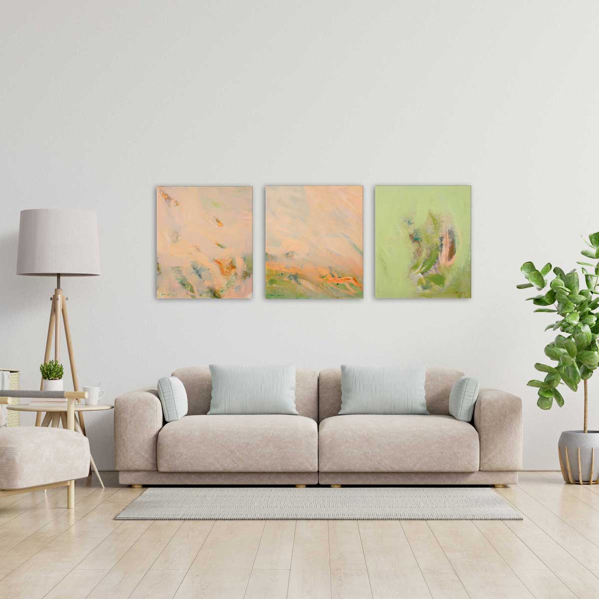 Living room with a beige sofa, three abstract paintings on the wall, and a lamp.