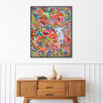 Load image into Gallery viewer, Colorful abstract painting with a lamb on a white wall above a wooden console table.
