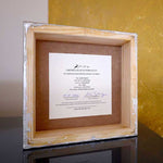 Load image into Gallery viewer, certificate of authenticity attached from the back side of the original small portrait painting wooden square frame standing on a shelf
